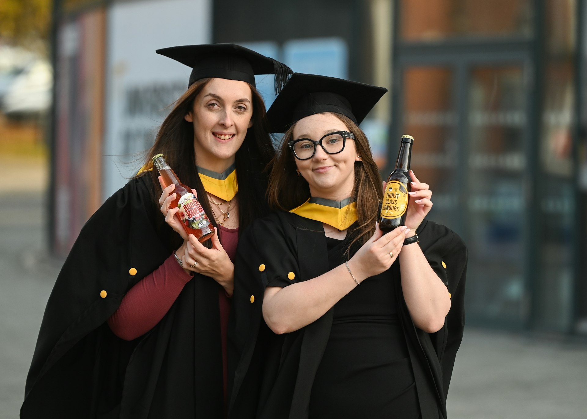 Adele Harris and Rebecca Mines holding their drinks